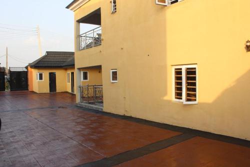 an empty courtyard of a house with a building at ODTC Homes and Apartments in Ibadan