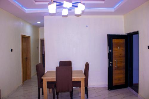 a dining room with a wooden table and chairs at ODTC Homes and Apartments in Ibadan
