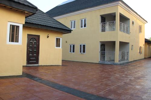 a large building with a large brick courtyard at ODTC Homes and Apartments in Ibadan