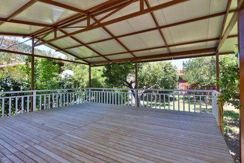 awning over a deck with a wooden walkway at Baris Pension & Bungalows in Cıralı