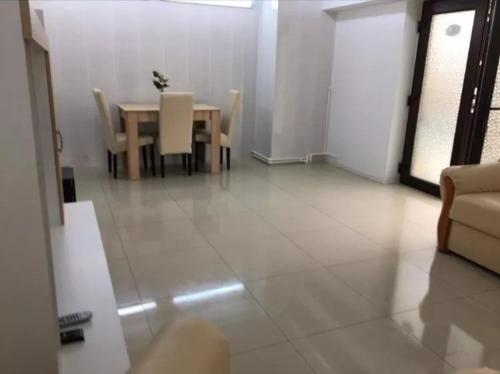 a dining room with a table and a table and chairs at apartament Sara in Mangalia