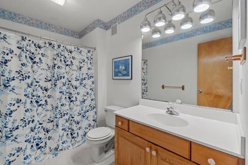 a bathroom with a sink and a toilet and a shower at 4670 - Shell-Y-Bration by Resort Realty in Southern Shores