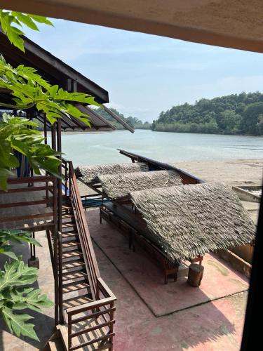 a group of tables with a view of the water at HOTEL RM in Nuquí
