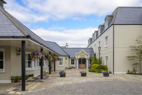 a row of white buildings with a courtyard at Meadowlands Hotel in Tralee