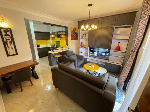 a living room with a couch and a table at Athena Apartments in Kampala