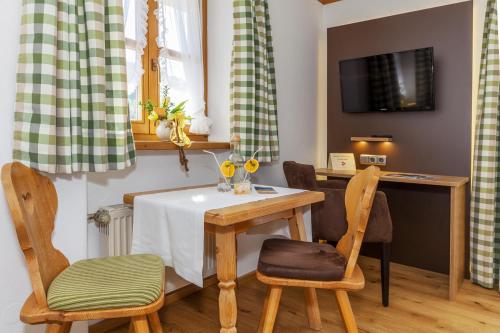 a dining room with a table and two chairs at Demelhof in Reit im Winkl