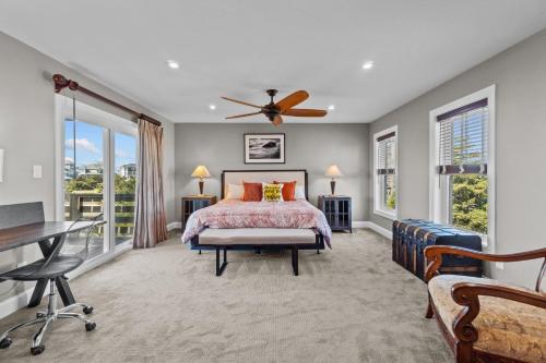 a bedroom with a bed and a desk and windows at 7015 - Nirvana by Resort Realty in Rodanthe