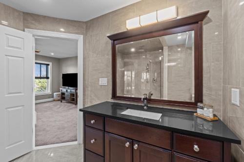 a bathroom with a sink and a large mirror at 7015 - Nirvana by Resort Realty in Rodanthe