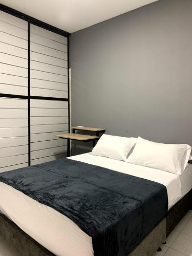 Hotel el Olimpo في إباغويه: غرفة نوم بسرير كبير مع بطانية سوداء