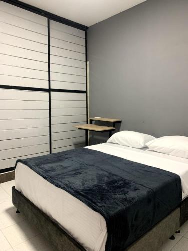Un pat sau paturi într-o cameră la Hotel el Olimpo