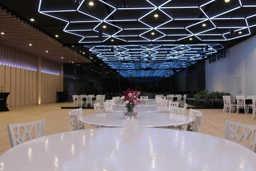 a banquet hall with white tables and white chairs at Piotruś Pan in Brzesko