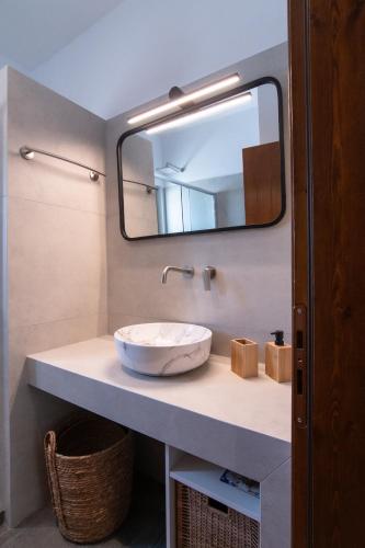 a bathroom with a sink and a mirror at aerie home Skyros in Skiros