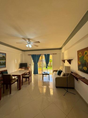 a living room with a couch and a table at Las Palmeras by Graziano in Boca Chica