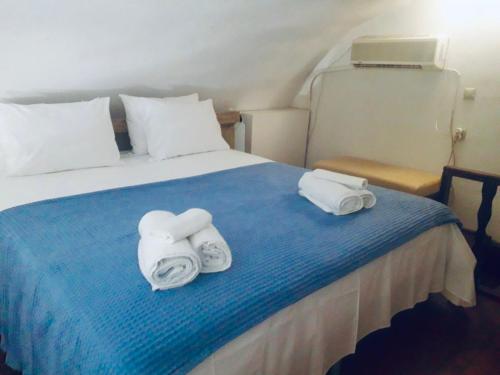 a hotel room with a bed with towels on it at Mastic castle house in Mestá