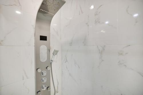 a shower in a bathroom with white marble walls at Large home in community w/pools&skiing in Bushkill