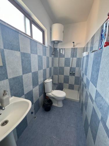 a bathroom with a toilet and a sink at Koa Studio 2 in Korçë