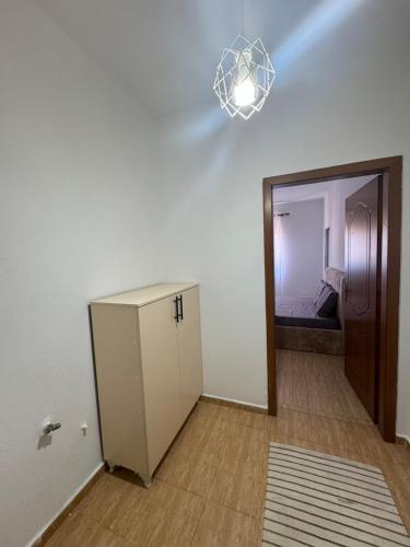 a room with a white cabinet and a mirror at Koa Studio 2 in Korçë