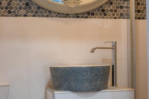 a bathroom with a sink on top of a toilet at Anxhelo Apartment in Kokkari