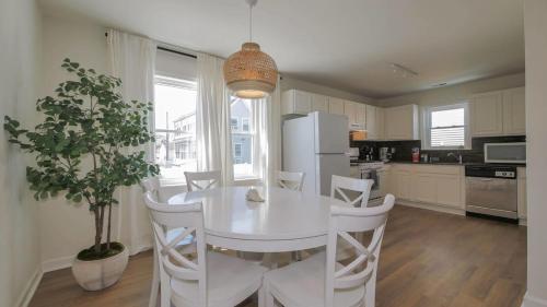 a kitchen with a white table and white chairs at North Beach Retreat in Atlantic City