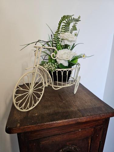 a flower arrangement in a bike basket on a table at Pensiunea Miruna in Moieciu de Jos