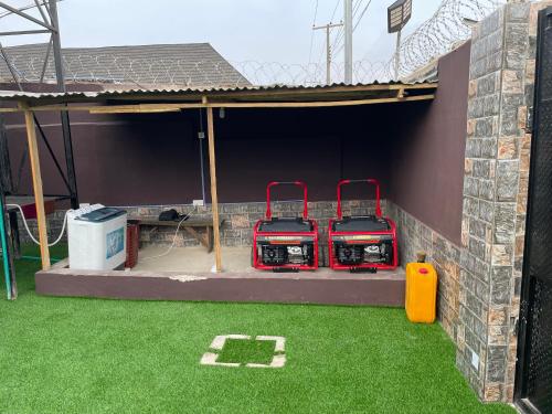two fire hydrants are sitting on a patio at belphus Apartment in Lagos