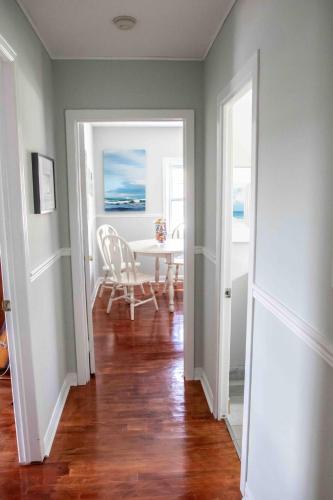 a room with a table and a dining room with a table at The Jypsy Inn - Journey Apartment Muskoka in Bracebridge