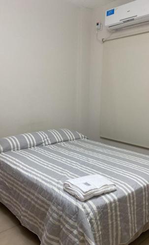 a bedroom with a bed with two towels on it at Departamento temporario in Corrientes