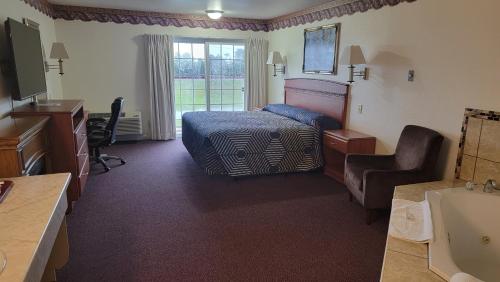 a hotel room with a bed and a bathroom at Oceanview Inn and Suites in Crescent City