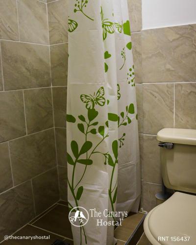 a shower curtain in a bathroom with a toilet at The Canarys Hostal in Santa Rosa de Cabal