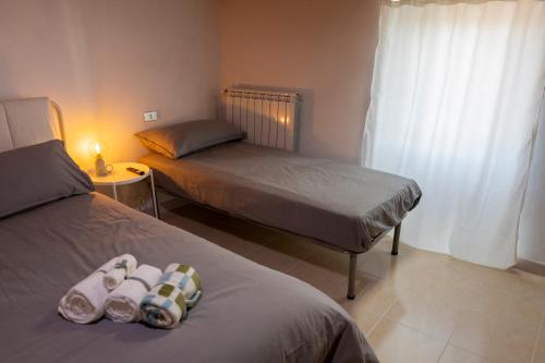 a bedroom with two beds and a window with a lamp at Casa Schioppo - Molise fells like Home in Carpinone