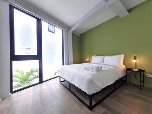 a bedroom with a large bed and a large window at Charming 2BR With Pool in Casco Antiguo in Panama City