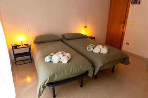 a bedroom with two beds with hats on them at Casa Schioppo - Molise fells like Home in Carpinone