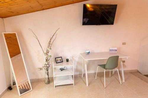 a white table and a chair in a room at Casa Schioppo - Molise fells like Home in Carpinone