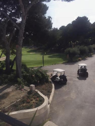 two golf carts are parked in a parking lot at Casa Villamartin Plaza Apartment in Villacosta