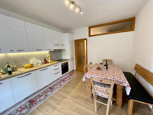 a kitchen with a table and a dining room at Apartment Weisswand in Colle Isarco