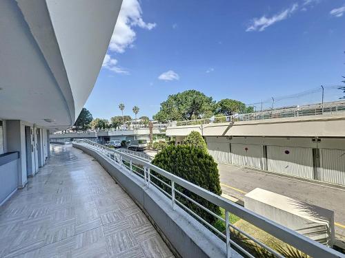 a balcony of a building with a fence and bushes at #T03 DUCAL MARINA BAIE DES ANGES avec Terrasse in Villeneuve-Loubet