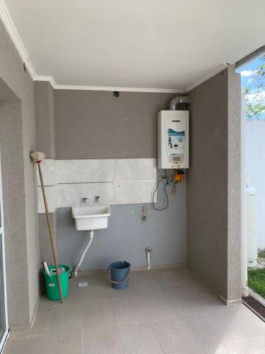 a bathroom with a sink and a water heater at Rio Victoria in Victoria
