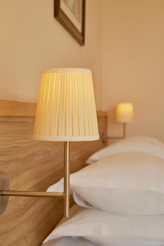a lamp sitting on the floor next to a bed at Villa Allende in Budva
