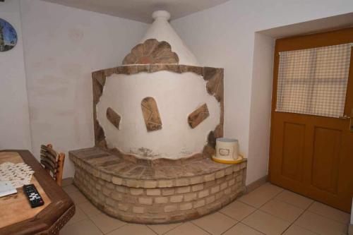 a brick fireplace in the corner of a room at Salaš Trikić in Aleksandrovo