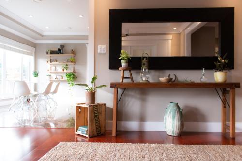 a living room with a large mirror on the wall at Welcome Home in North Vancouver
