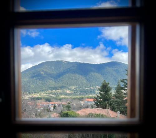 a view of a mountain through a window at Anastasia's Suites Arcadia in Vytina