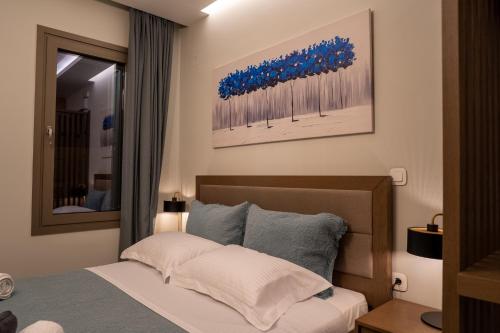 a bedroom with a bed and a mirror at Akti Vigla Apartments in Mytilini