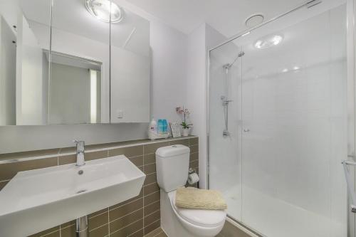 a bathroom with a toilet and a sink and a shower at A Cozy & Comfy Studio Next to Southern Cross in Melbourne