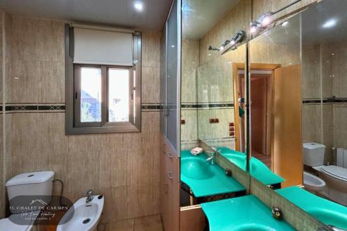 a bathroom with two blue sinks and a mirror at Chalet de Carmen in Castelldefels