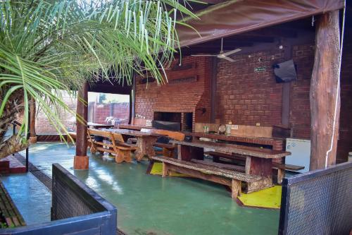 a restaurant with wooden benches and a table at Terra Iguazú Cabañas in Puerto Iguazú