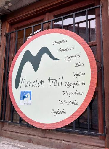 a sign in a window of a building with words at Anastasia's Suites Arcadia in Vytina