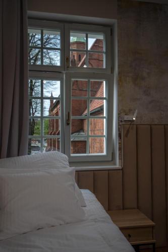 a bedroom with a bed looking out a window at Soul House Gdansk Old Town in Gdańsk