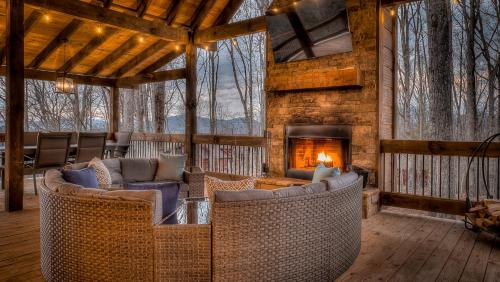 a living room with couches and a fireplace in a cabin at Clocking Inn in Mineral Bluff
