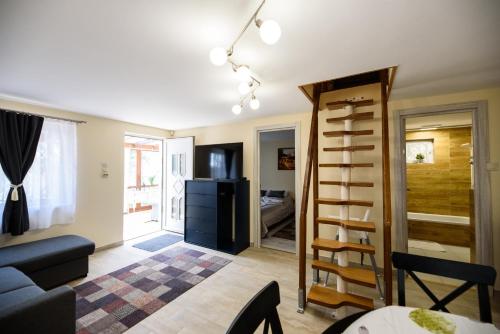 a living room with a stairs leading to a kitchen at Emili Apartman Ráckeve in Ráckeve