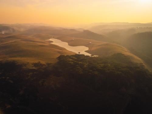 an aerial view of a river in a valley at Glamping Atmosphera in Cambara do Sul
